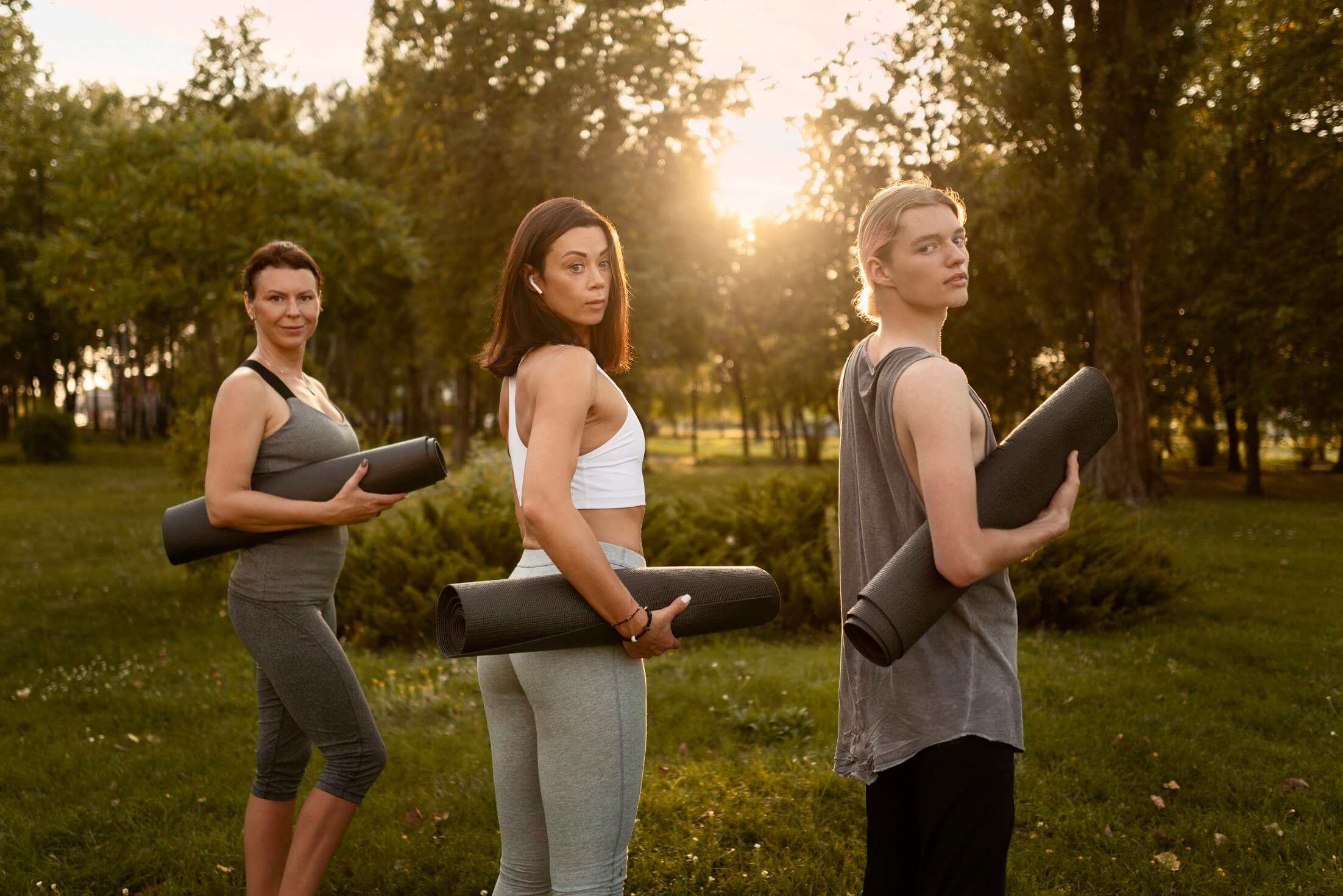 side view women holding yoga mats (1)